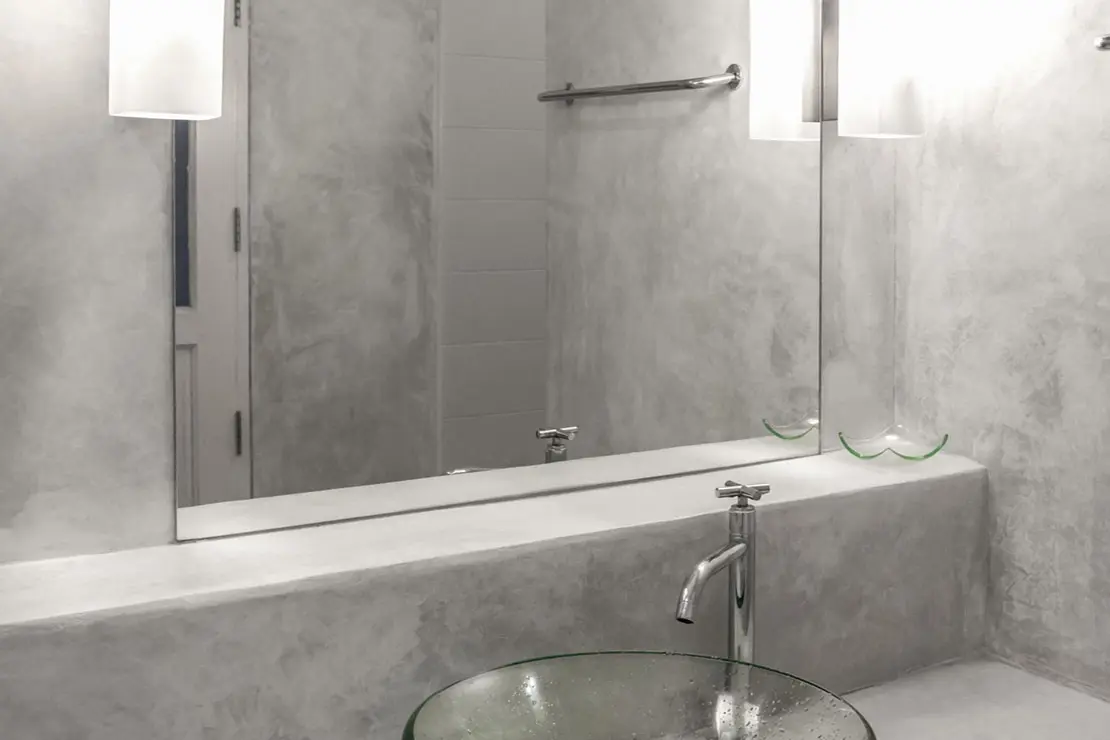Aseo con muros y superficie de microcemento de color gris Aseo con muros y superficie de microcemento de color gris